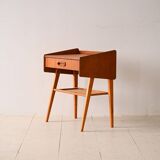 Bedside table with rattan magazine rack