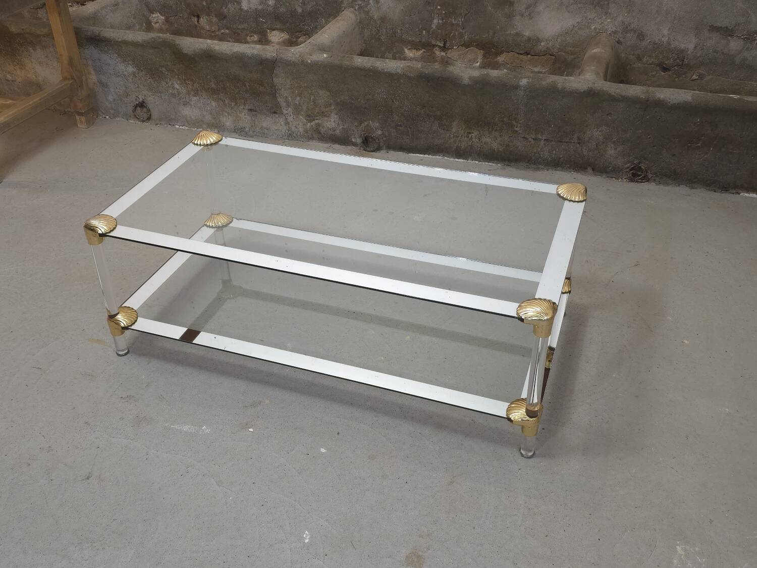 Coffee table, living room table in glass with two tiers, adorned with golden seashells, 1970.