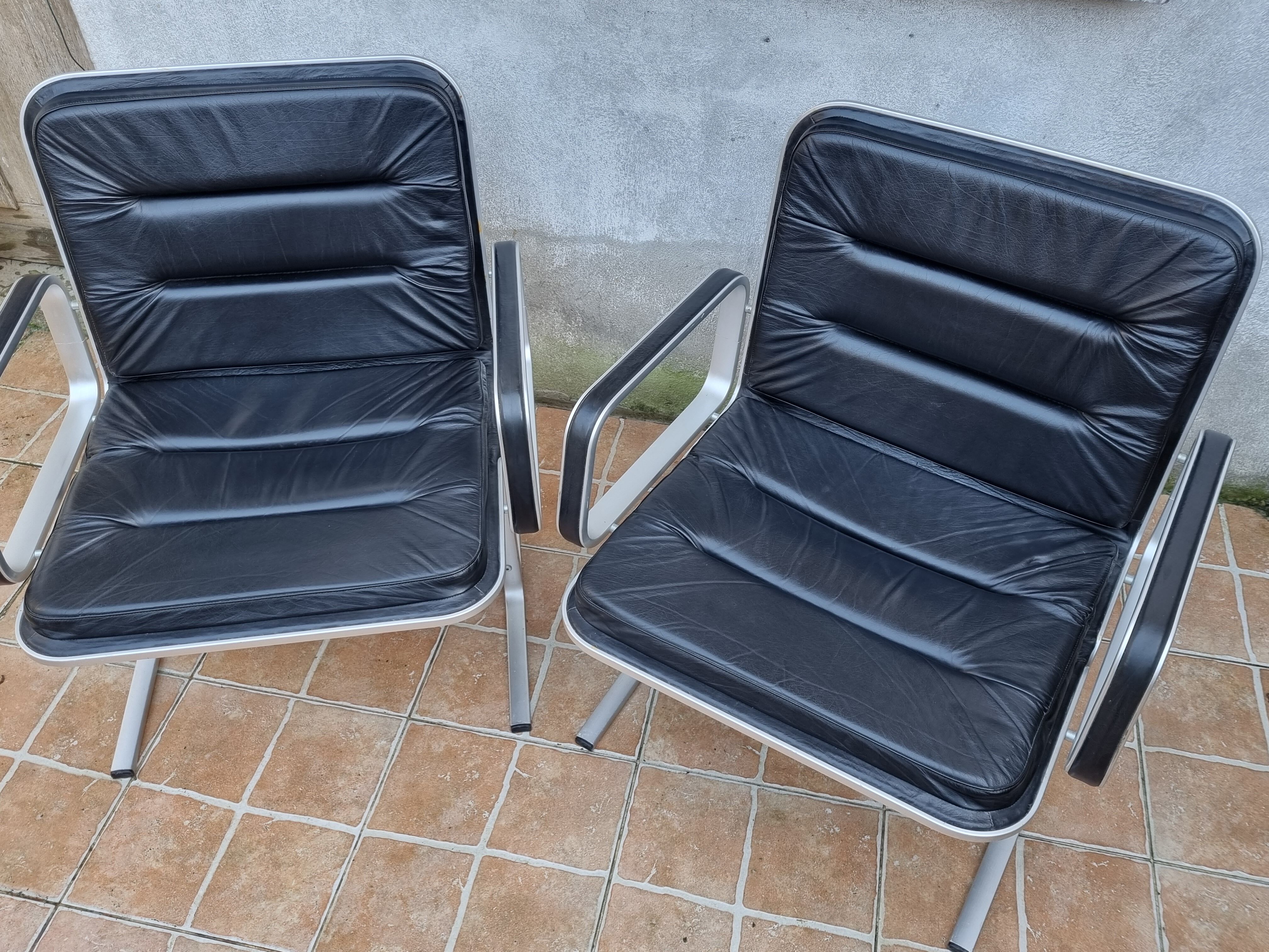 Pair of vintage leather and aluminum armchairs, restored