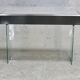 Modernist console, 1960s, glass base, wooden and fabric top.