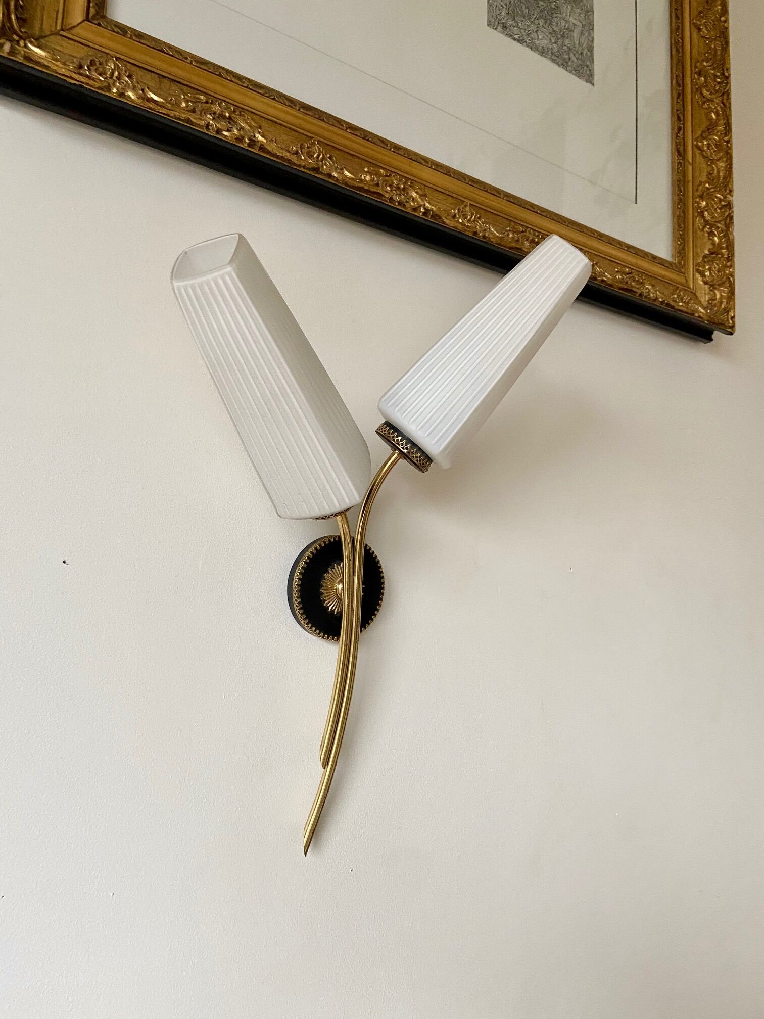 Black and gold metal wall and white opalines sconce