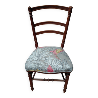 Antique chair with parrot fabric