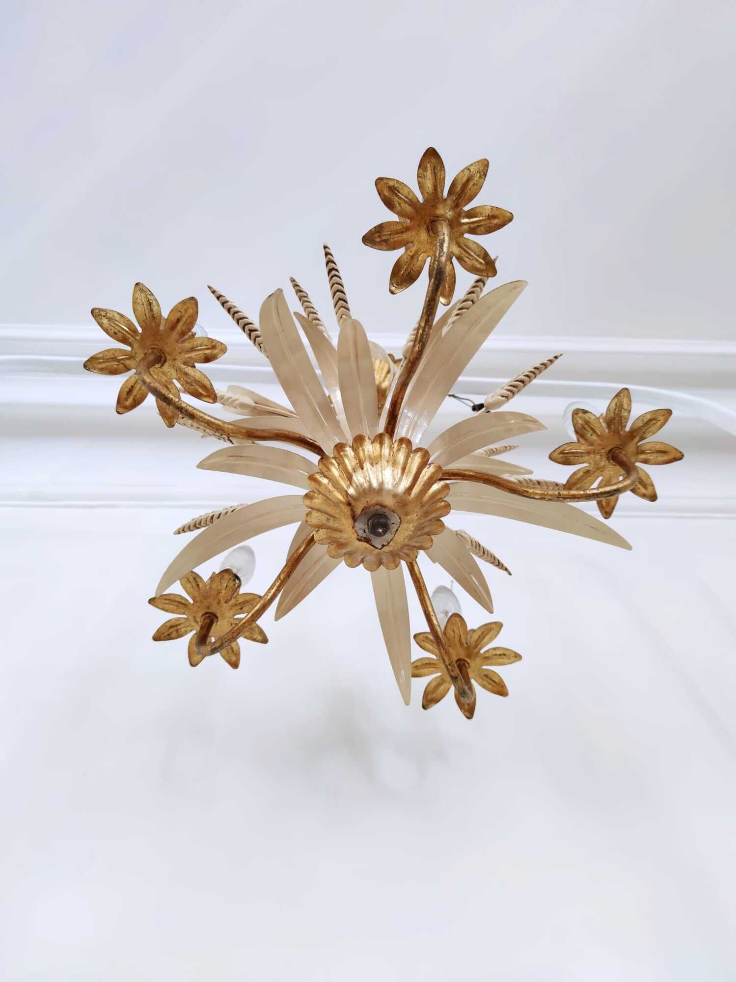 Vintage wrought iron chandelier decorated with golden and beige reeds