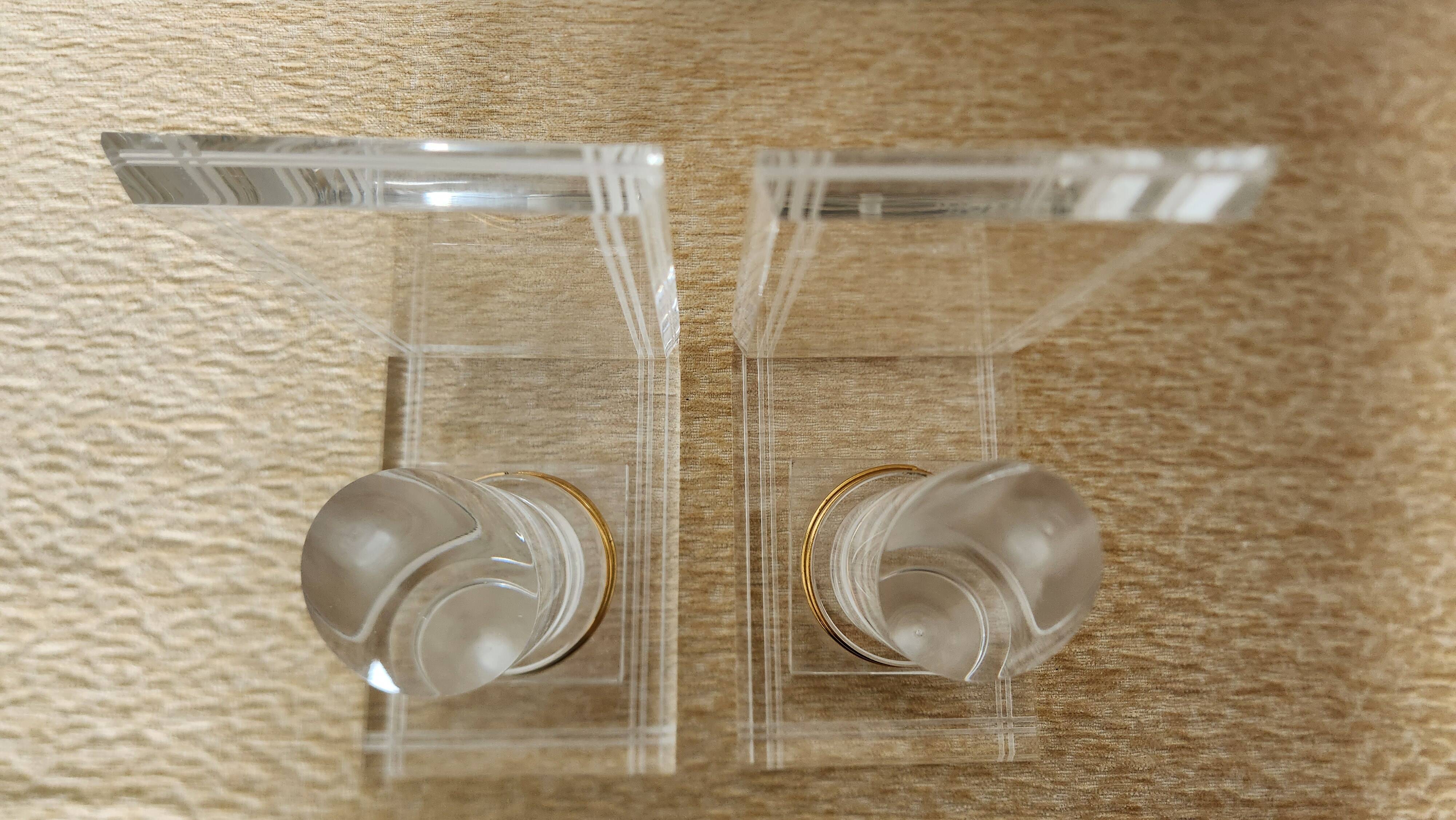 Pair of column bookends in plexiglass and gold metal, 1980s design.