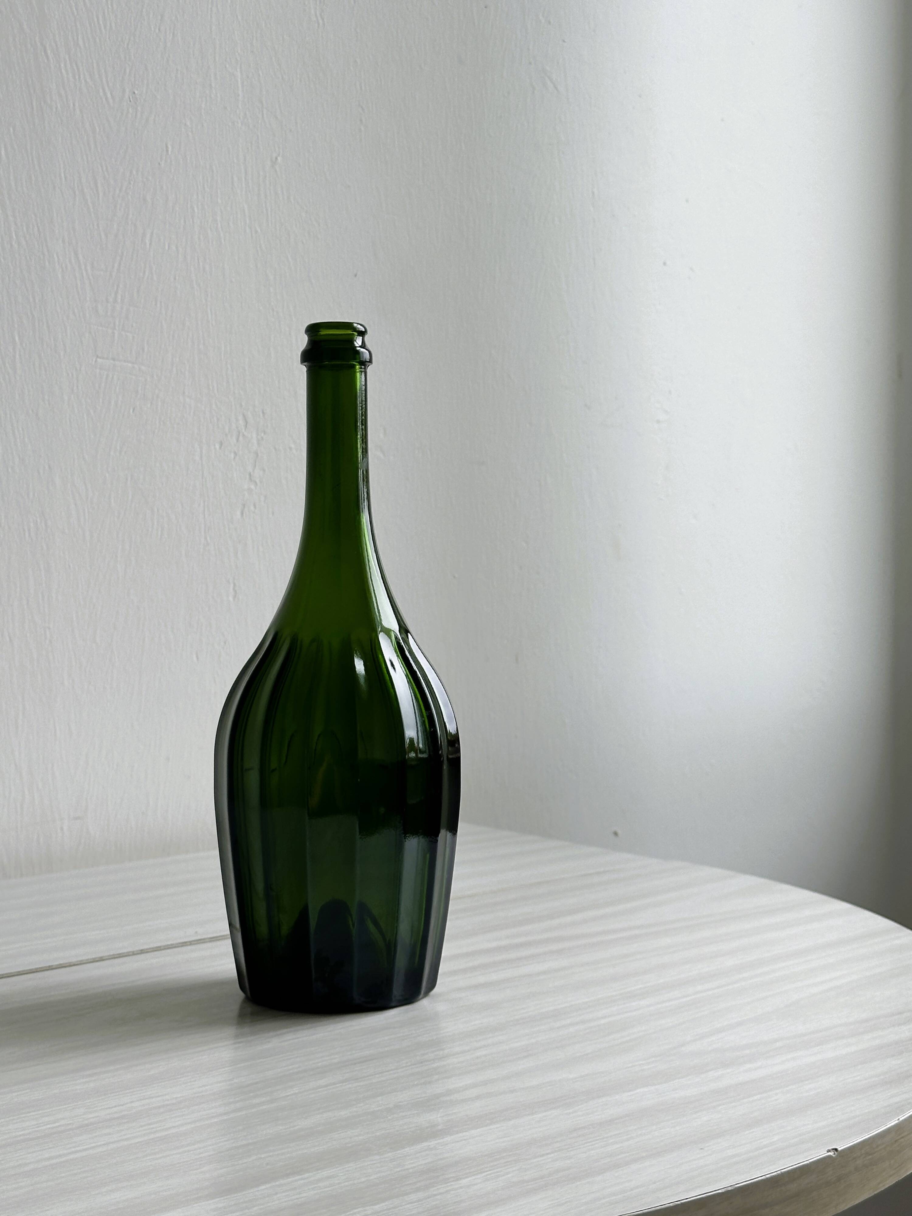 Translucent green glass bottle, classic design.