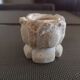 Candlestick in carved stone, signed