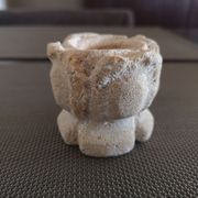 Candlestick in carved stone, signed