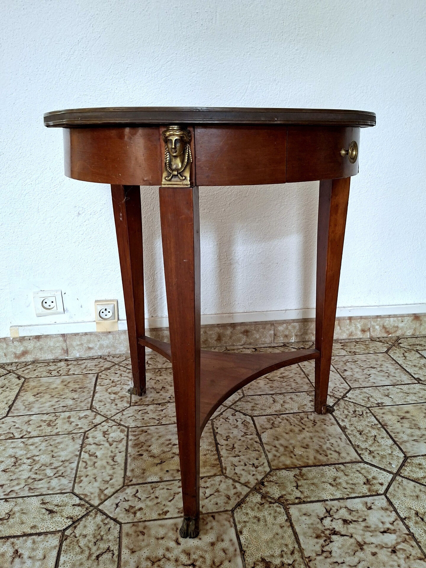 Empire guéridon table in mahogany with a black marble top and gilded bronze.