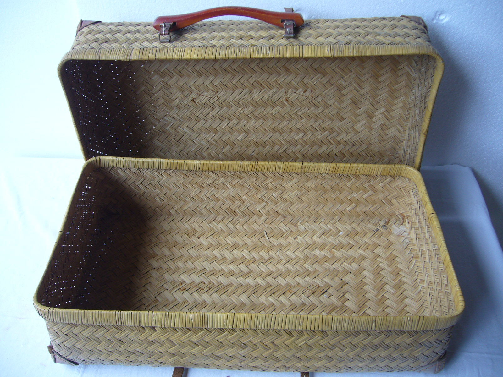 Old rattan case with leather straps and wooden handle
