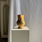 Large antique handmade ochre yellow jug with a pink flower pattern.