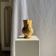 Large antique handmade ochre yellow jug with a pink flower pattern.