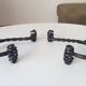 Brutalist wall coat rack in wrought iron.