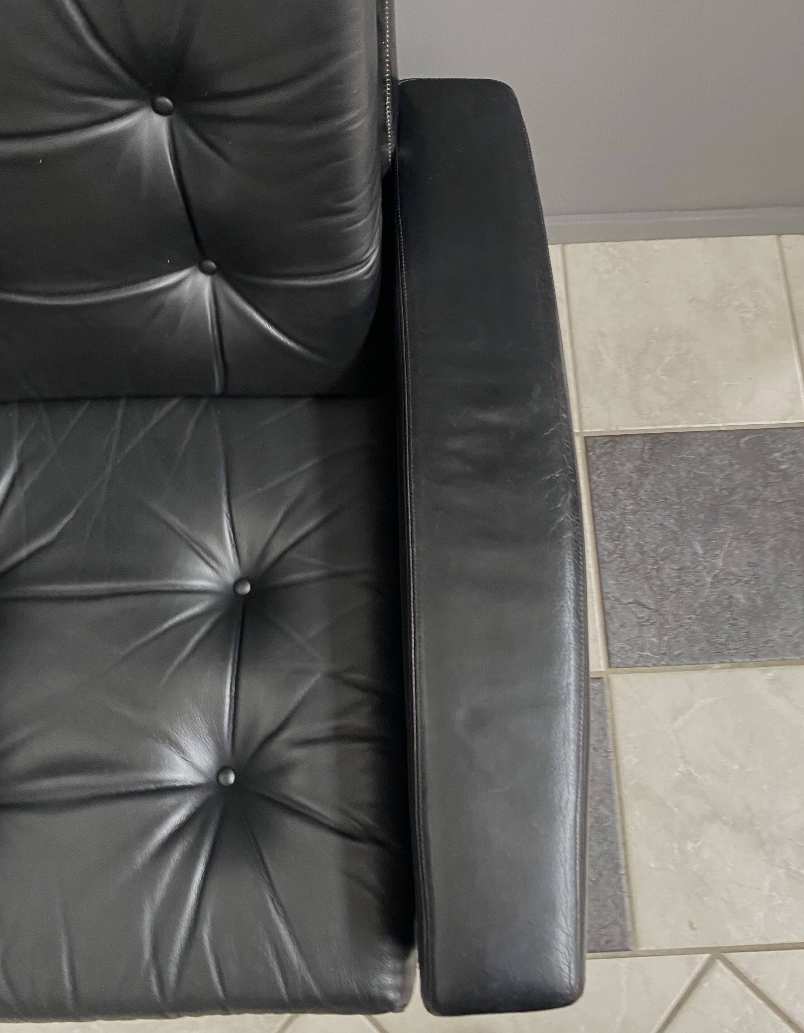 2 Black leather arm chairs 1960s on wheels