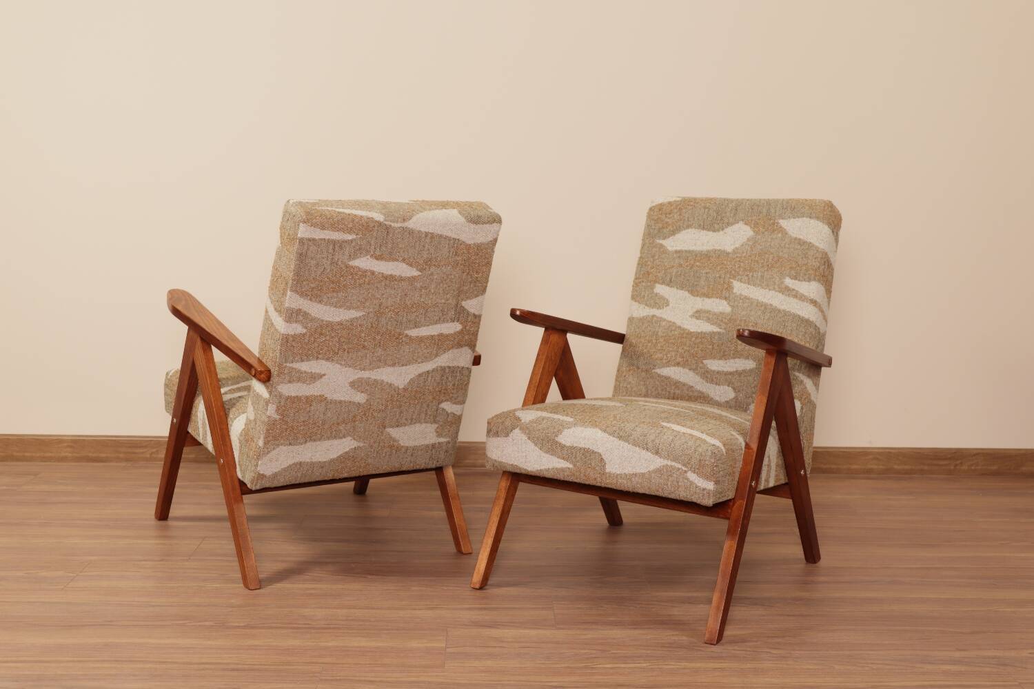 Pair of vintage lounge chairs in brown jacquard fabric and wood.