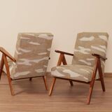 Pair of vintage lounge chairs in brown jacquard fabric and wood.