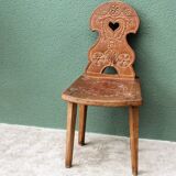 Old Swiss escabelle chair in carved wood