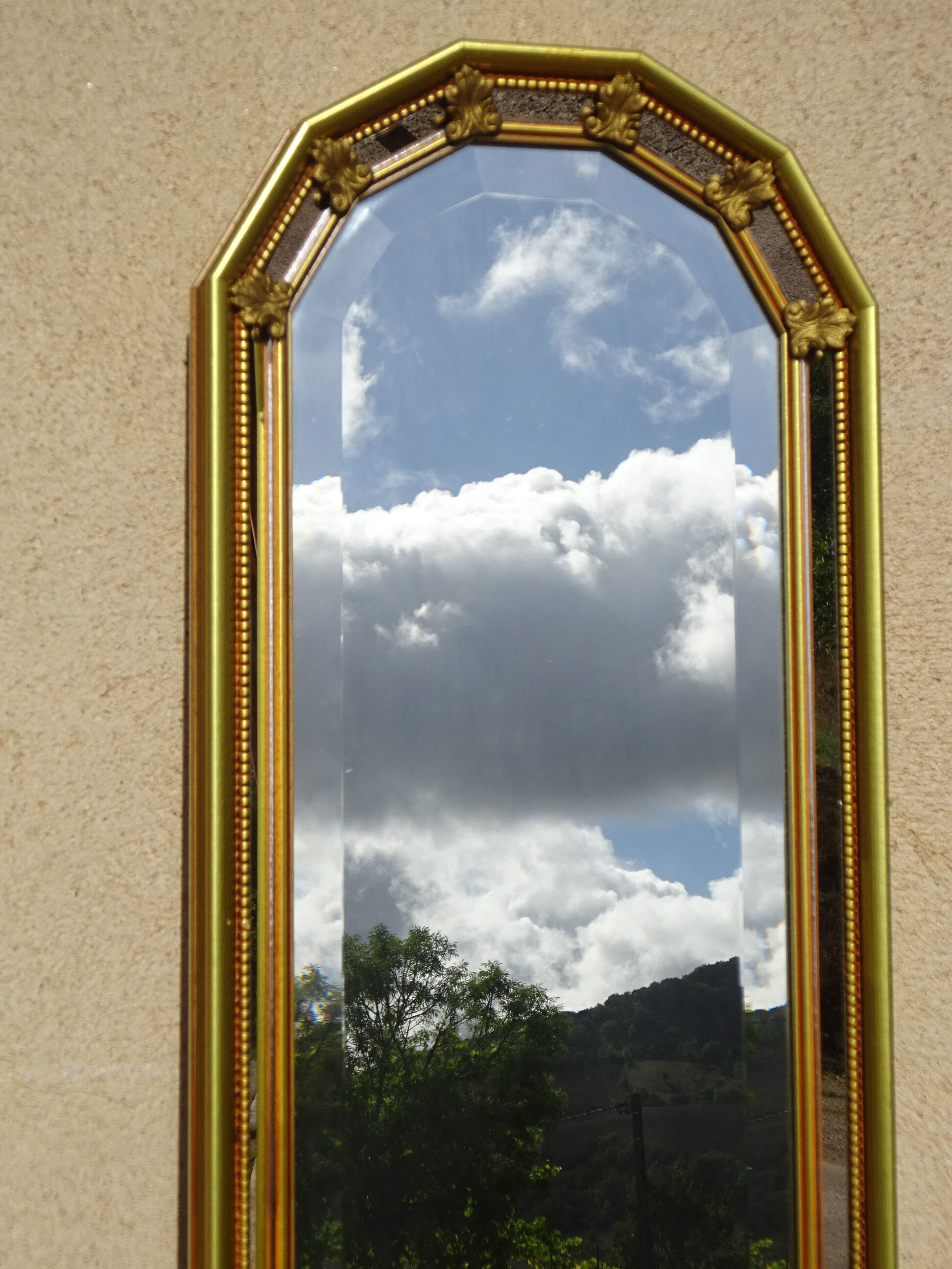 Vertical mirror, gold frame with beading.