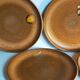 Four vintage glazed stoneware potter's plates