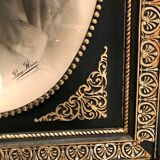 Black and gilded ebonite frame, wood and plaster 19th century
