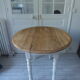 Oval table with beaded grey patinated flaps, wooden tray