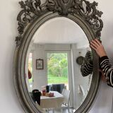 Beveled oval mirror in wood and stucco