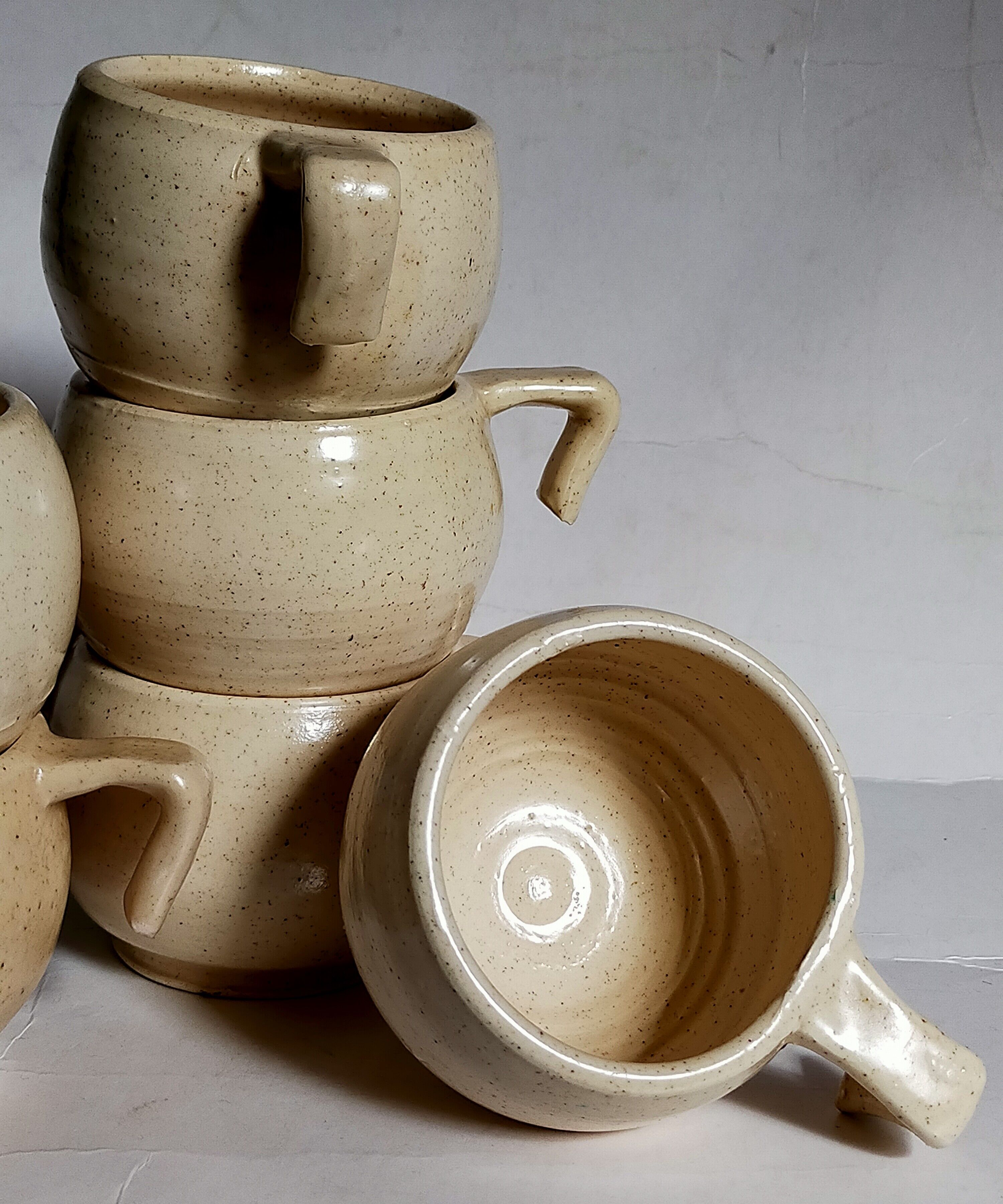 Six vintage potter's ceramic cups with vanilla enamel