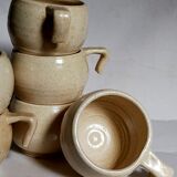 Six vintage potter's ceramic cups with vanilla enamel