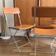 4 folding Sintesi chairs for DWR Lina in metal and vintage camel leather.