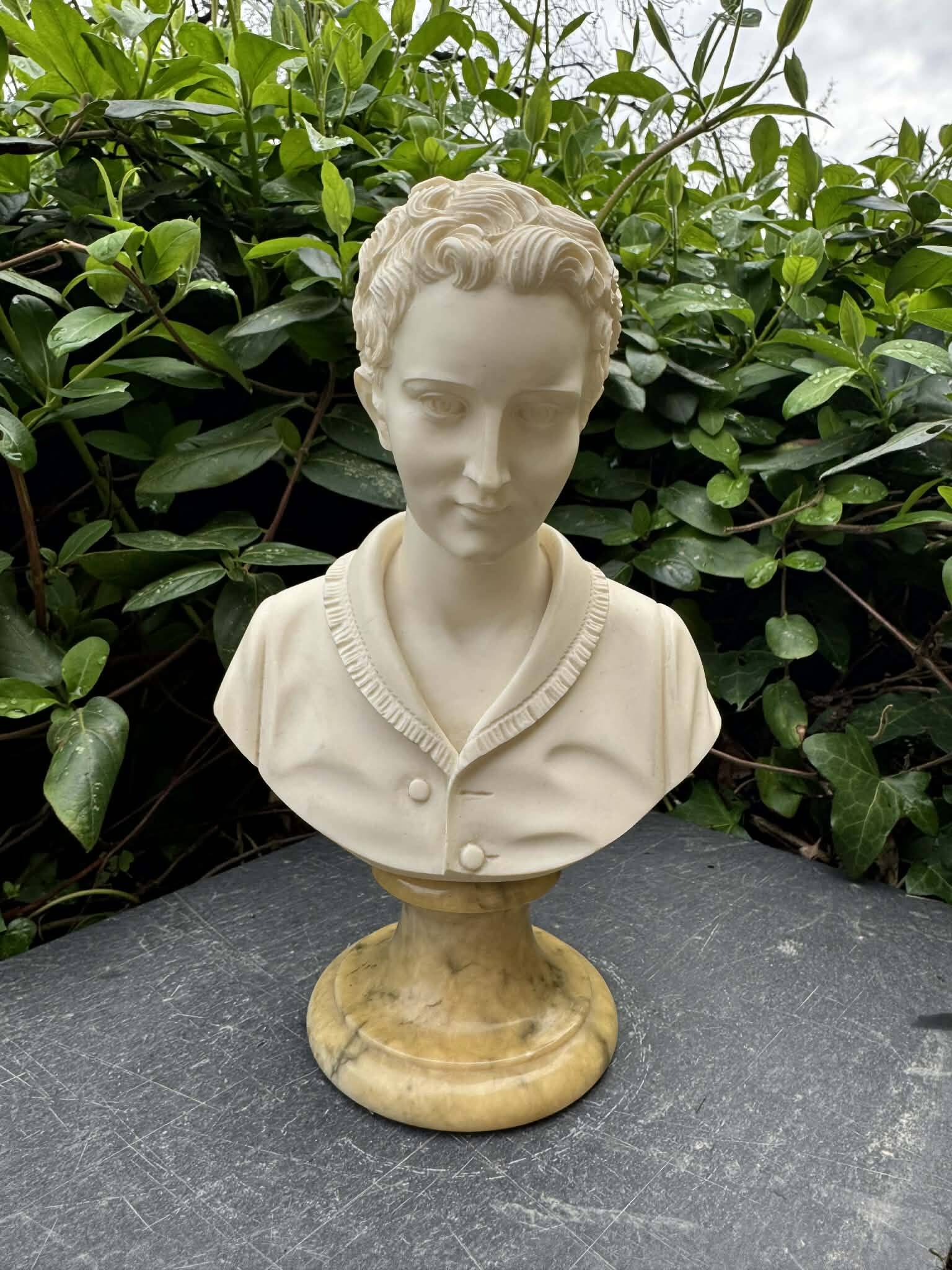 Alabaster bust of a woman signed Arnaldo Giannelli.