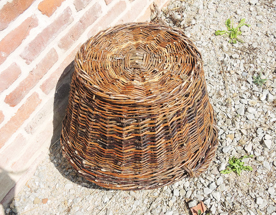 Old round wicker linen basket, dark rattan