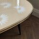 Tripod coffee table with floral design from the 1950s in brass metal and decorative top.