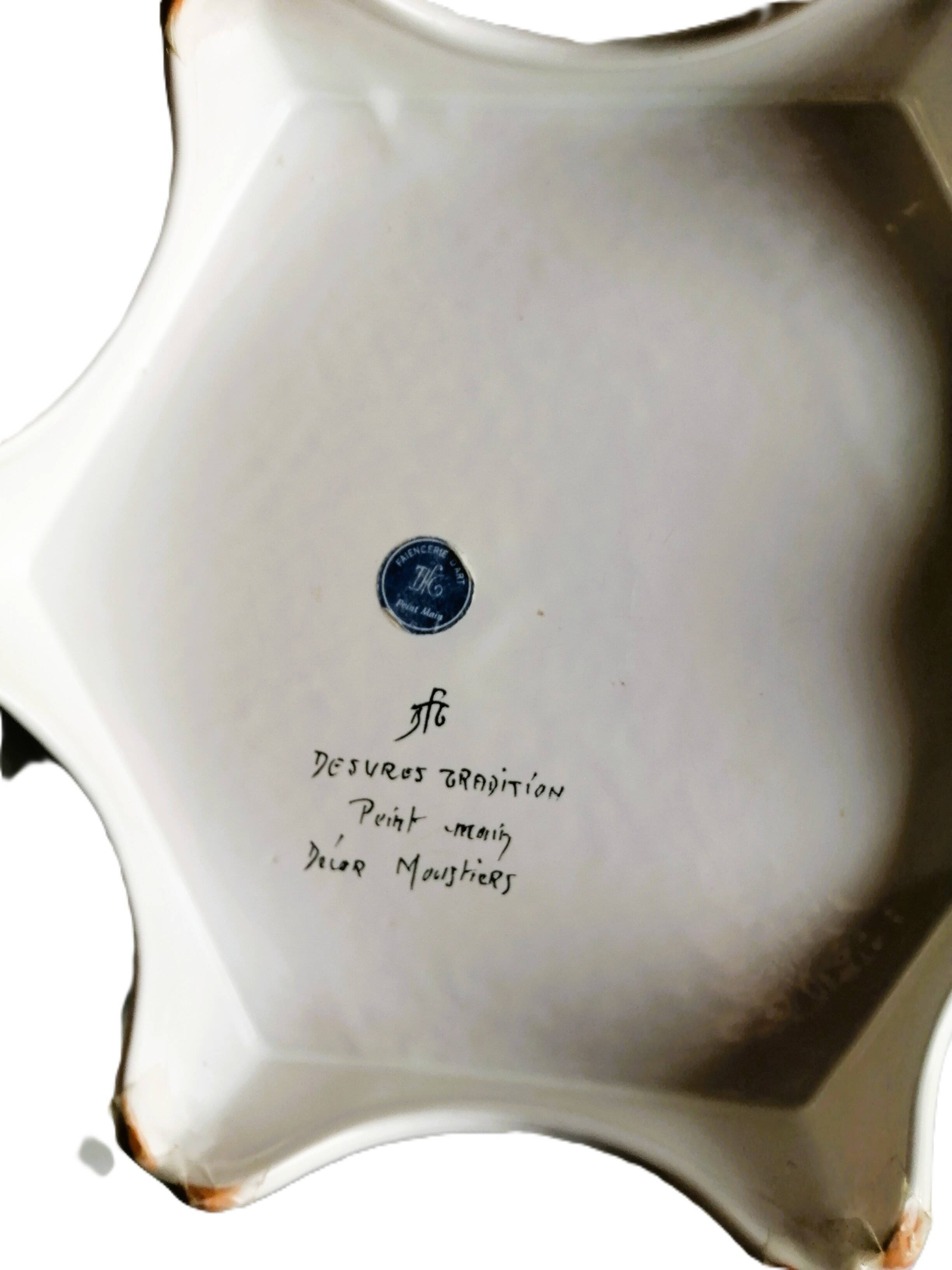 Hand-painted flat dish decorated in the Moustier style.