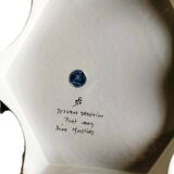 Hand-painted flat dish decorated in the Moustier style.