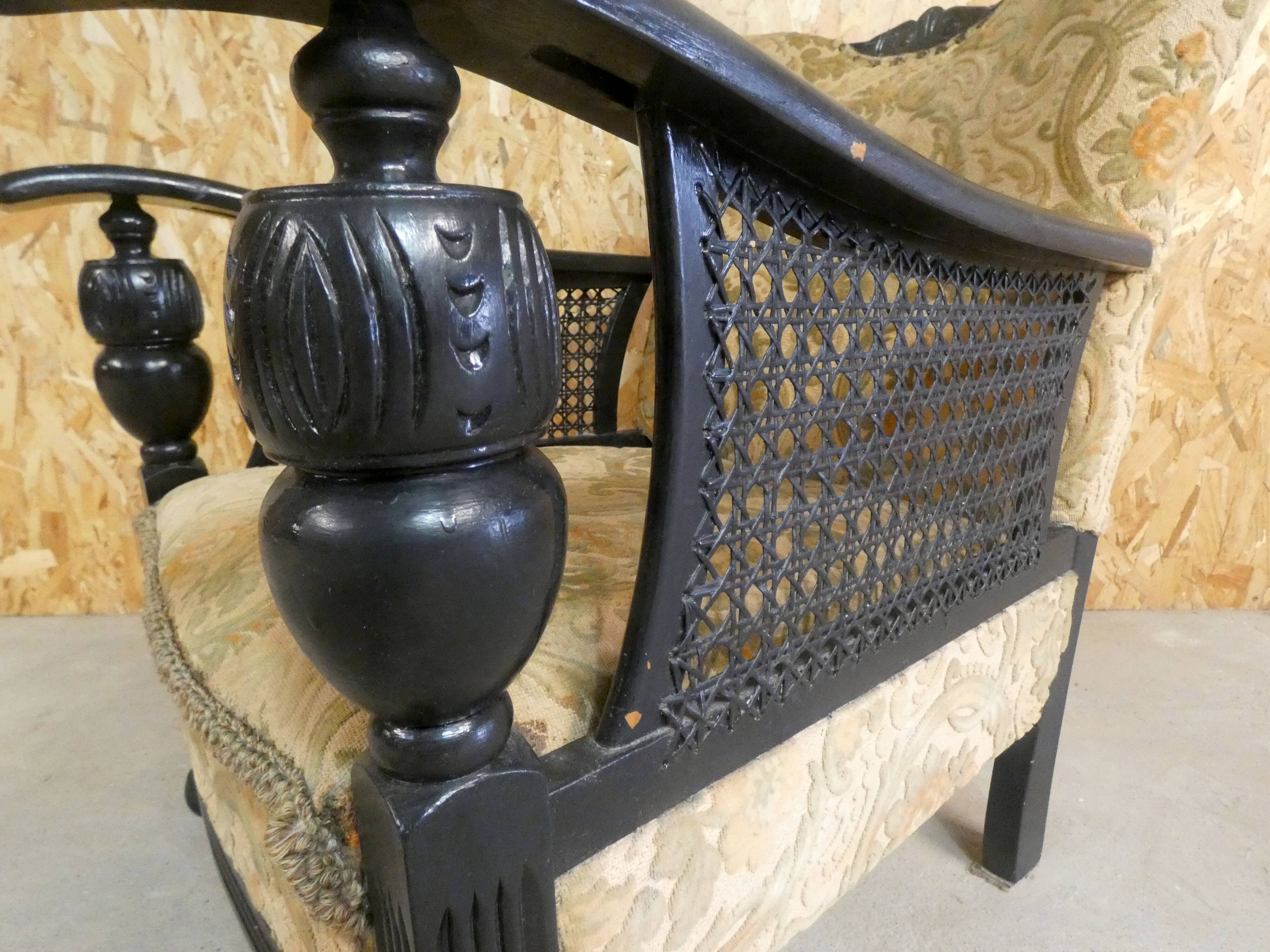 Old armchair upholstered in velvet, carved and caned wood