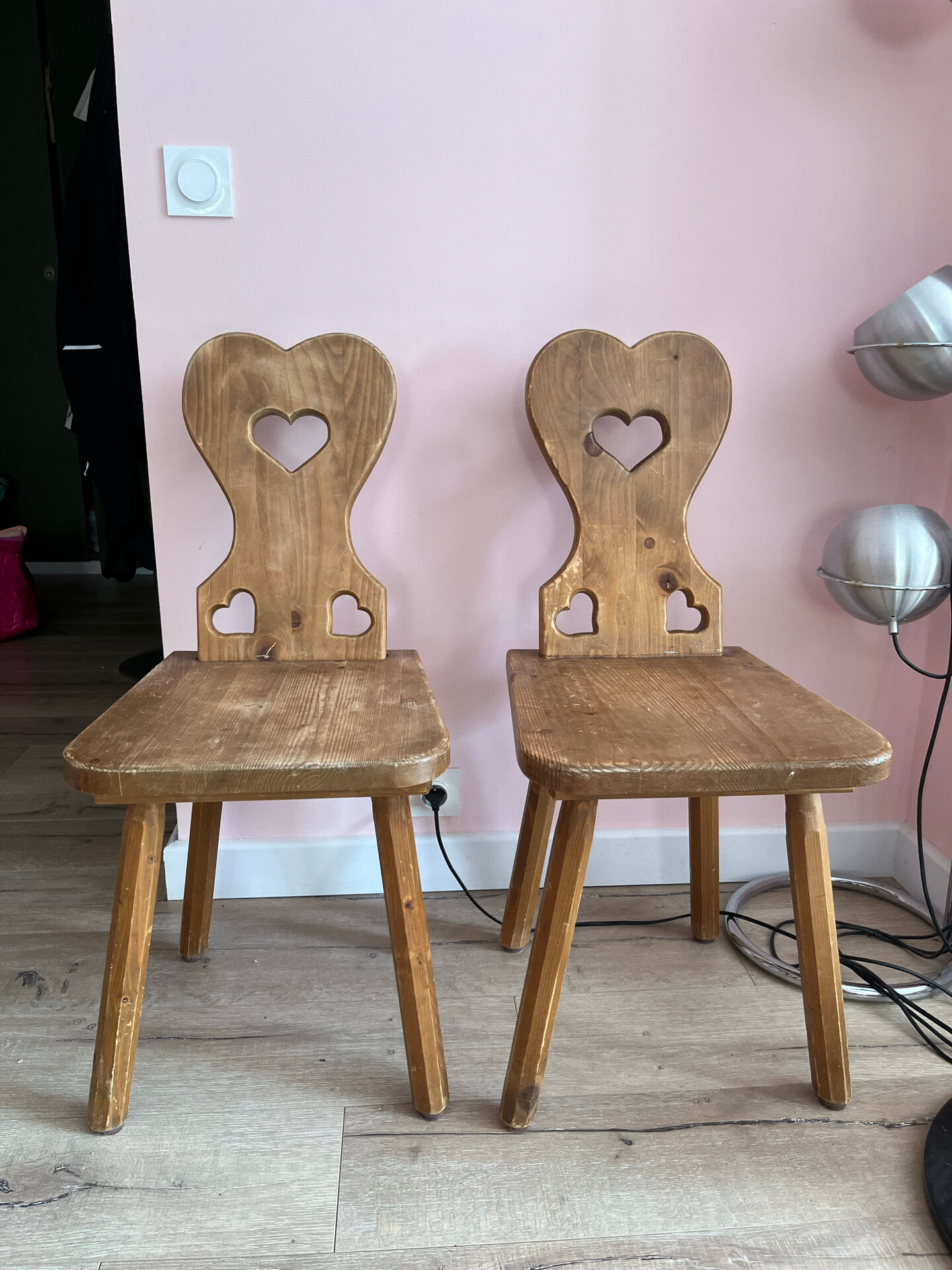 Pair of vintage wooden chairs in alpine chalet style.