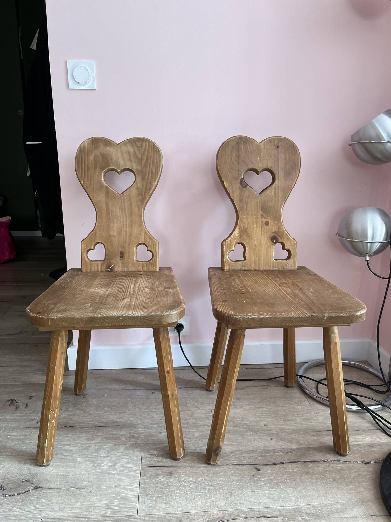 Pair of vintage wooden chairs in alpine chalet style.