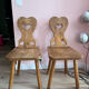 Pair of vintage wooden chairs in alpine chalet style.