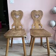 Pair of vintage wooden chairs in alpine chalet style.