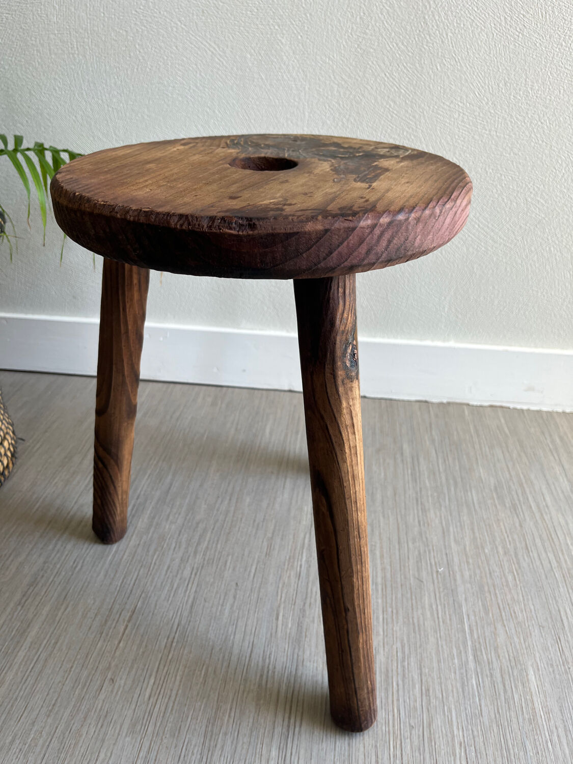 Three-legged wooden stool