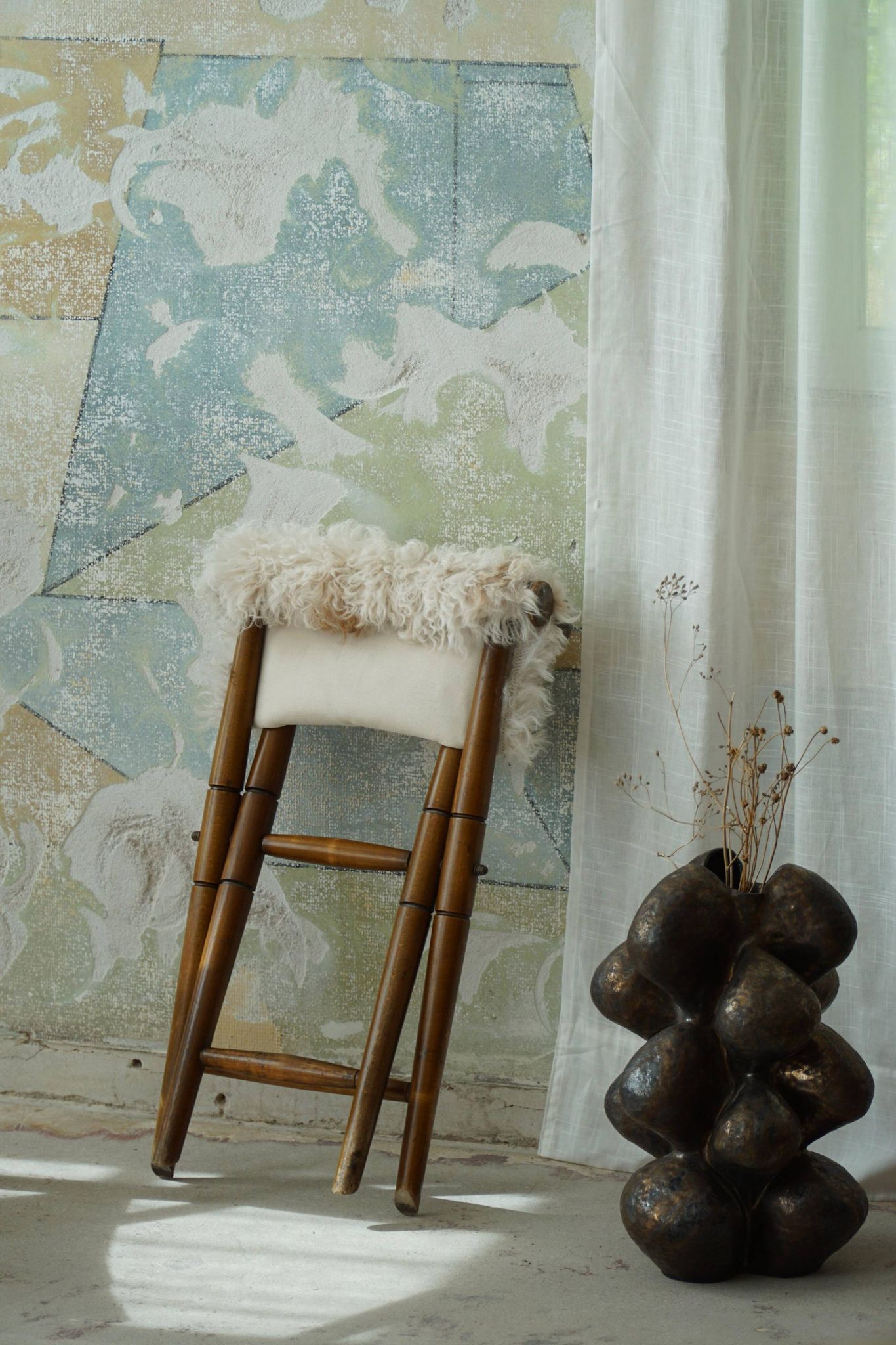 Folding stool, reupholstered in long-haired sheepskin, mid-century modern style, 1950s.
