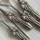 Antique small spoons with a metal bow design