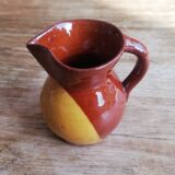 Small two-tone brown-yellow terracotta pitcher