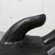 Black armchair chair in carved wood in the shape of a hand