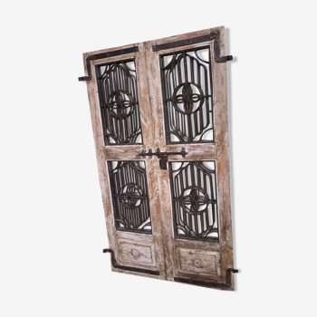 Old chiseled teak door with openwork wrought iron panels