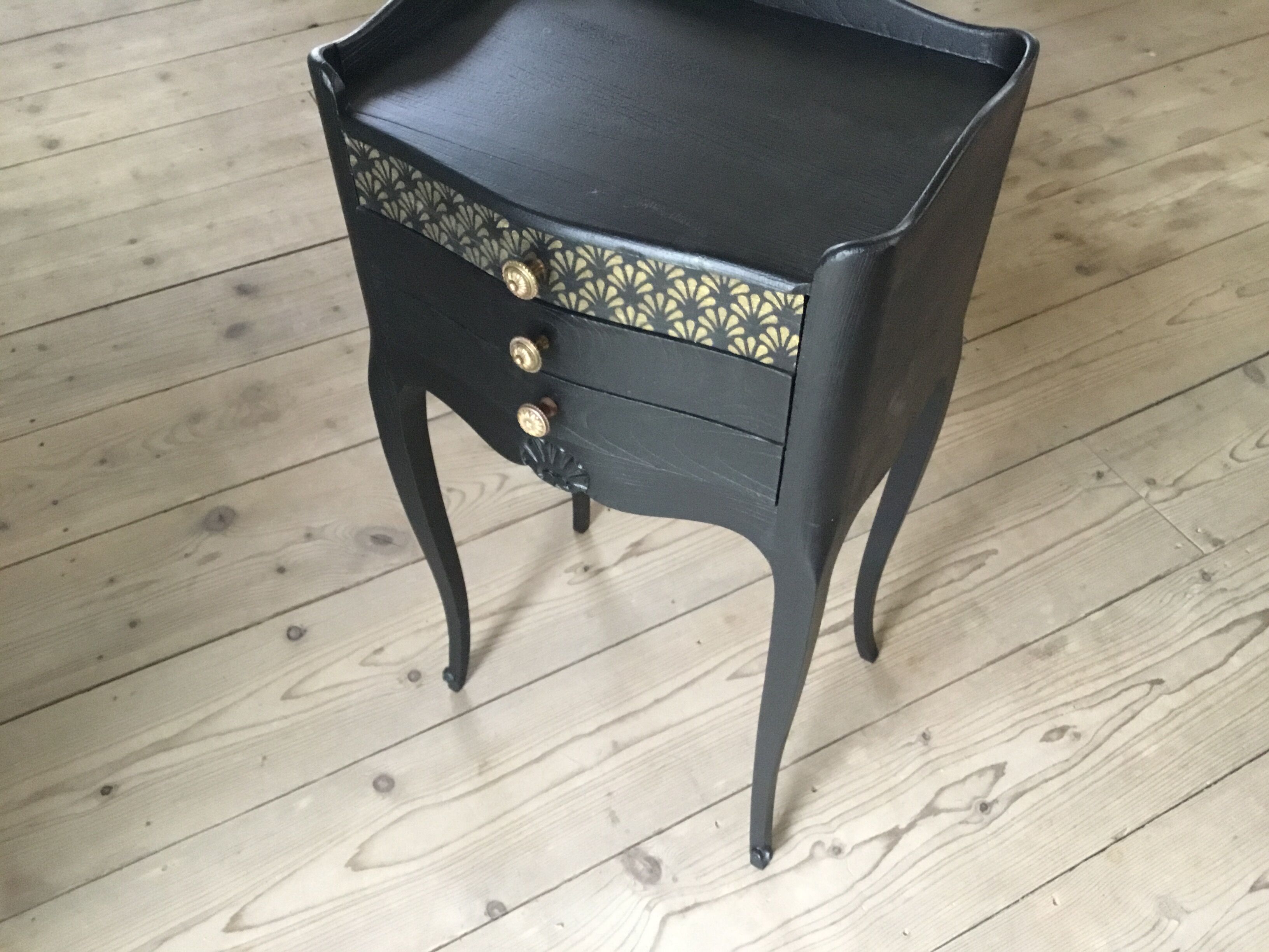 Bedside or nightstand painted black with patterns