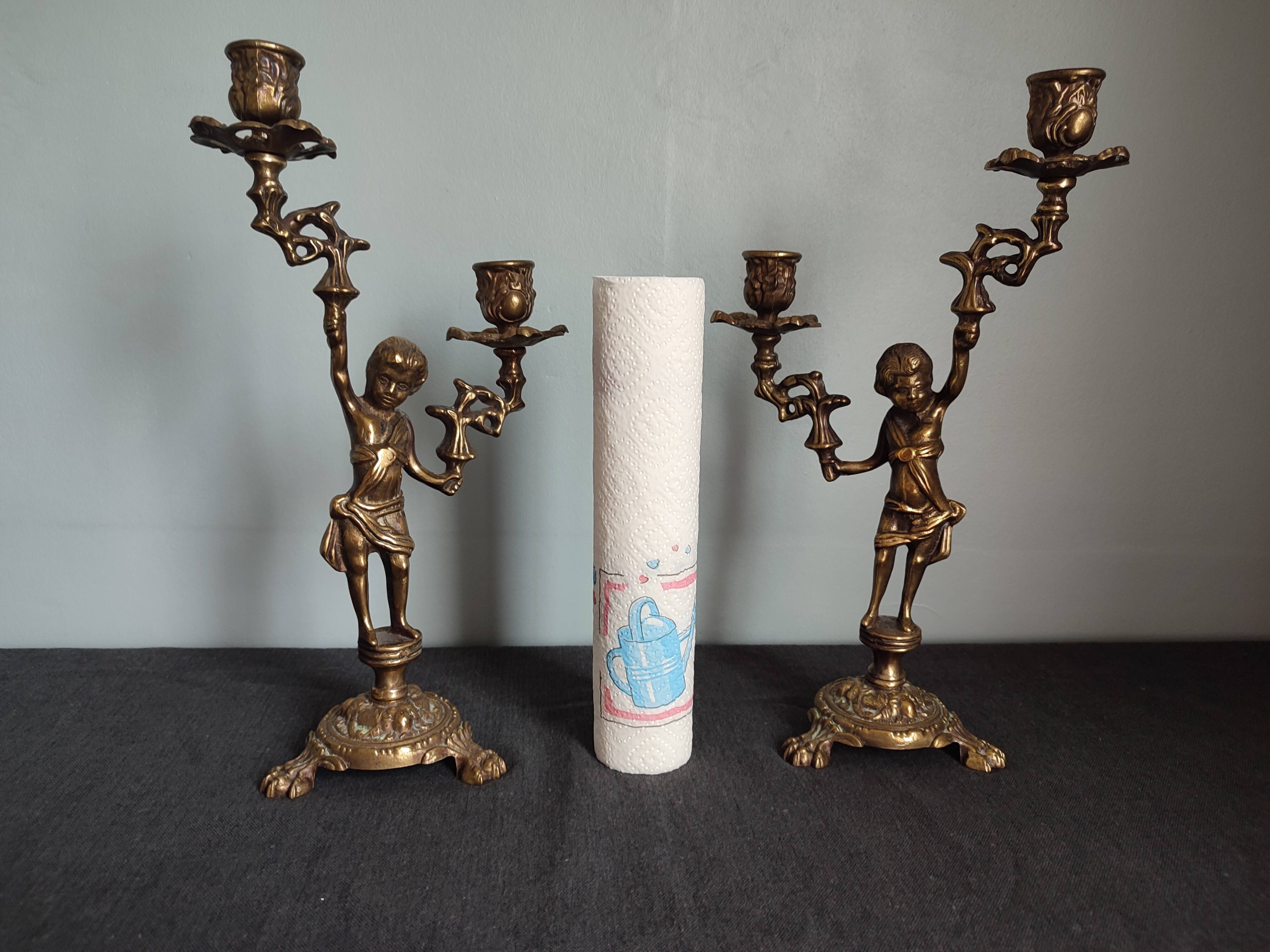 Pair of antique candlesticks in cherub bronze