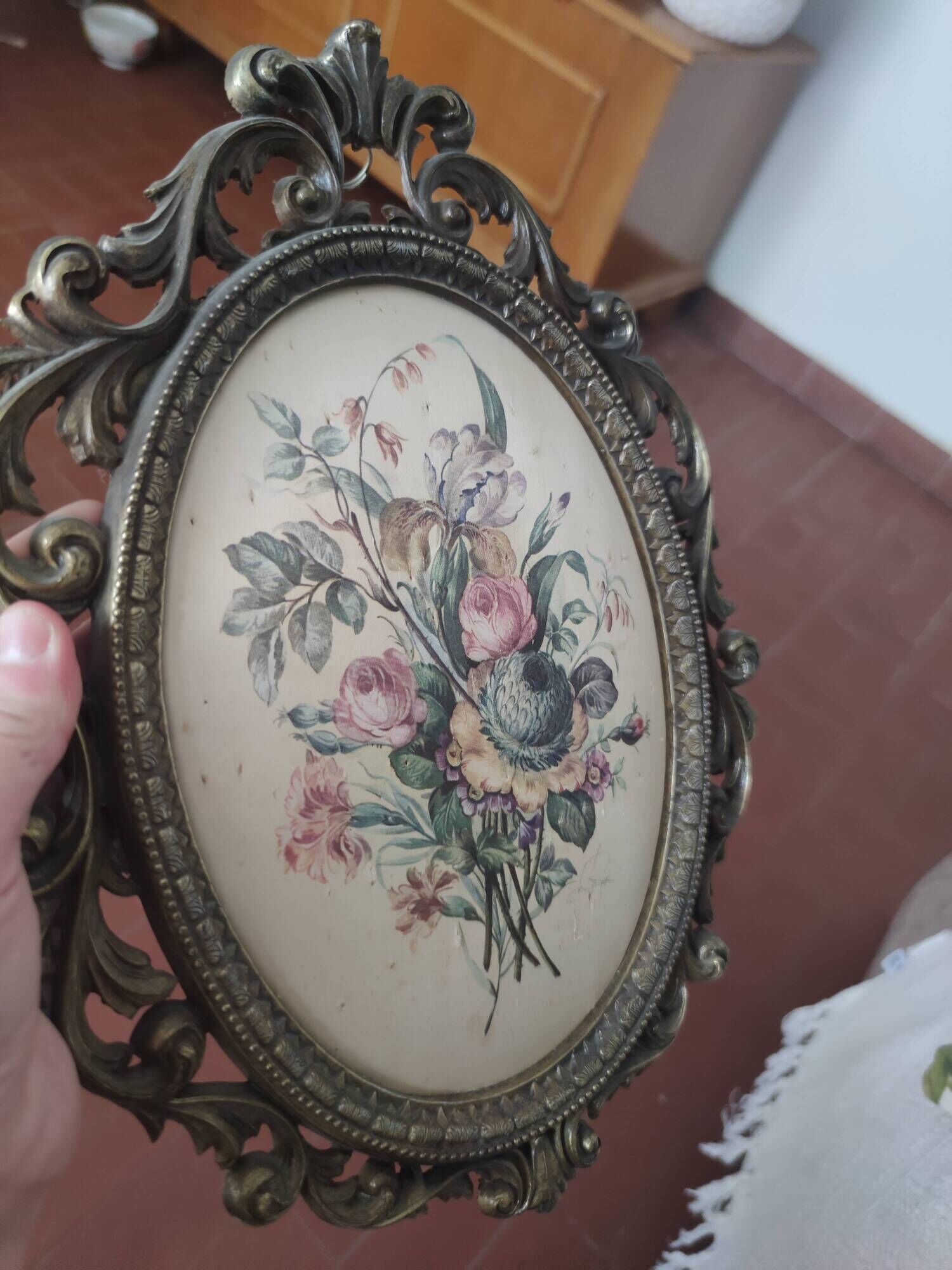 Golden brass frame with bouquet of flowers on silky fabric
