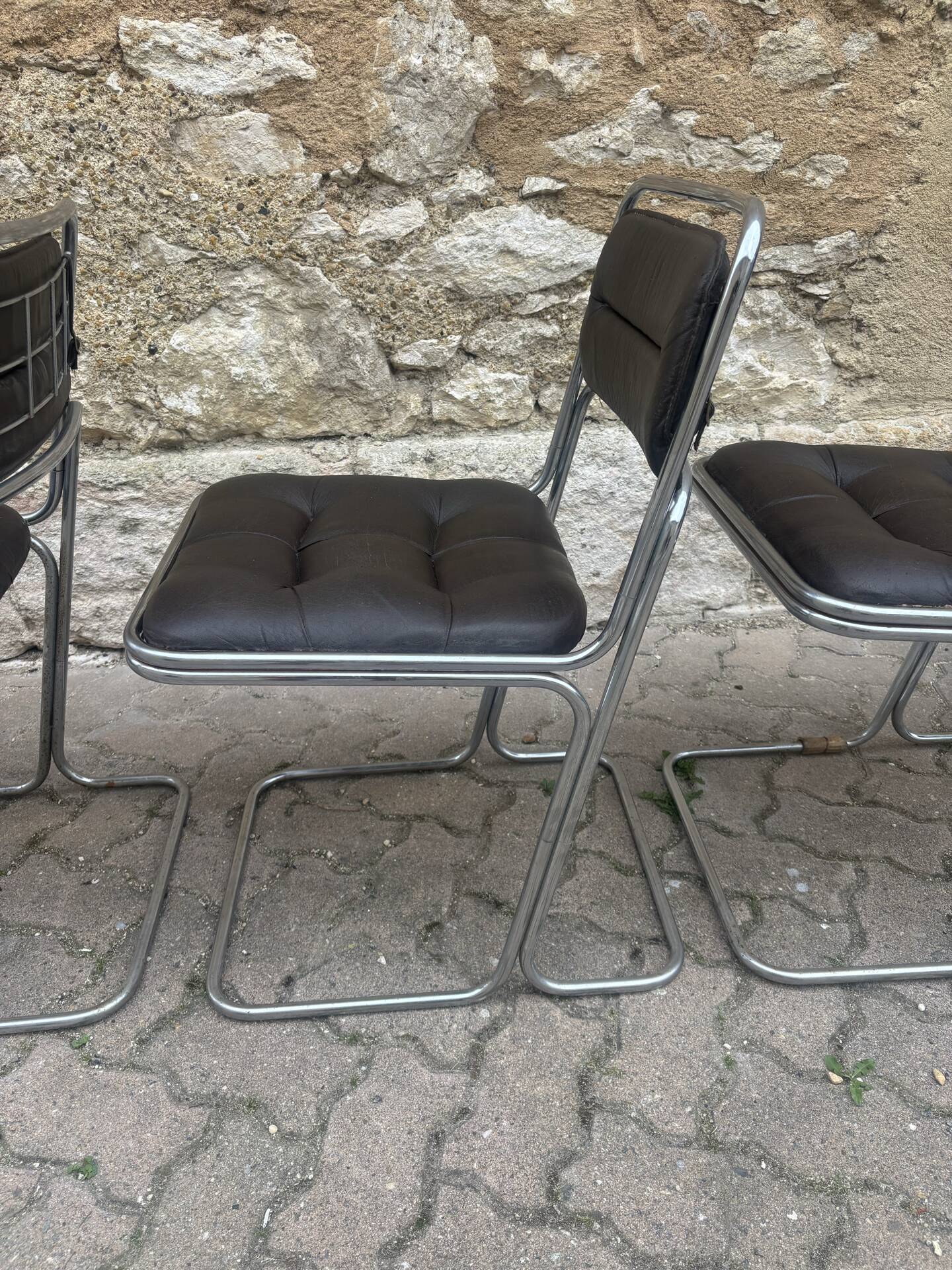 Four vintage chairs from the 1960s and 1970s, chrome with faux leather.