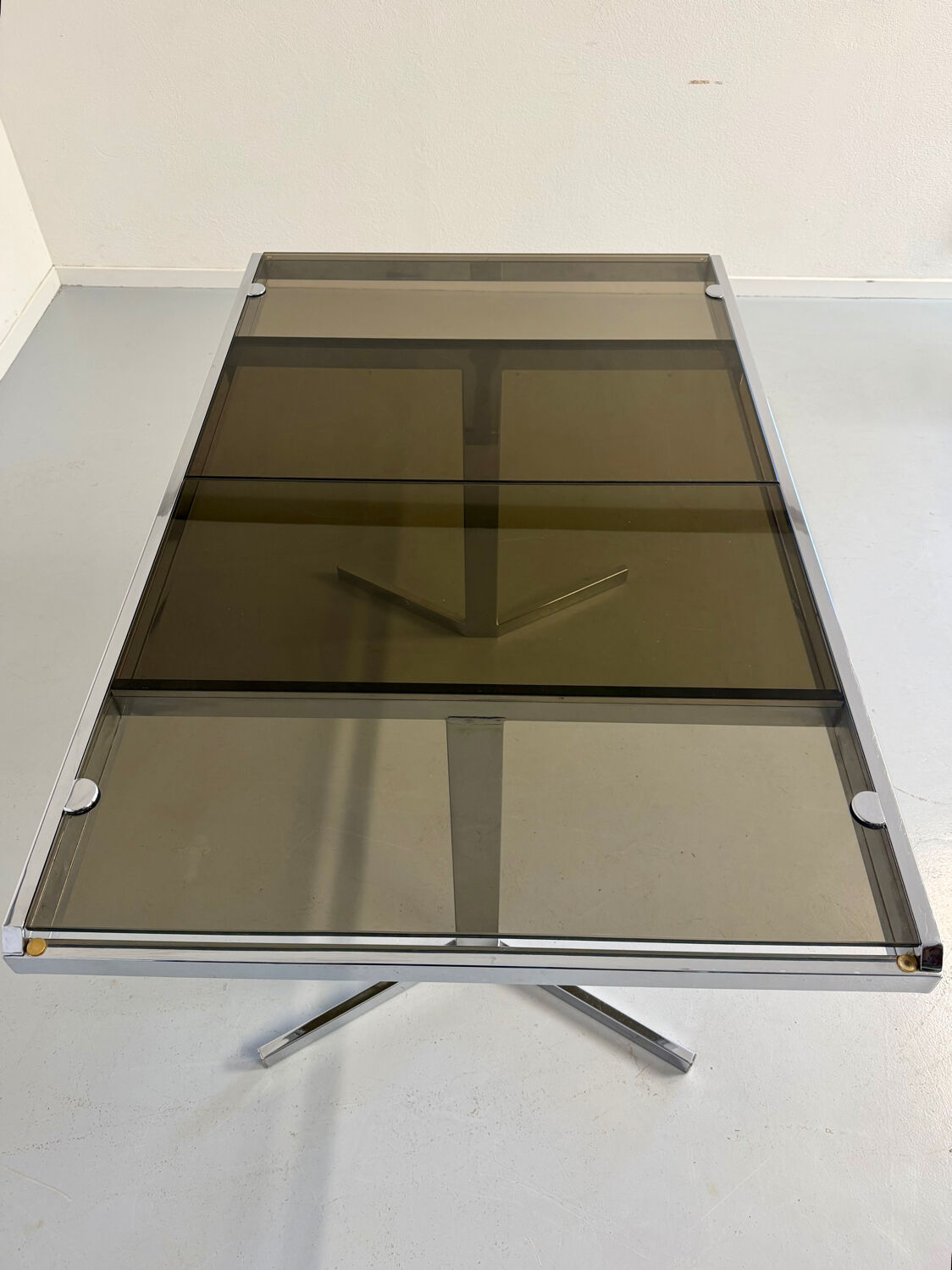 Smoked glass dining table with chrome legs, 1970s design by Roche Bobois.