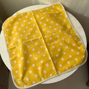4 yellow napkins with white polka dots